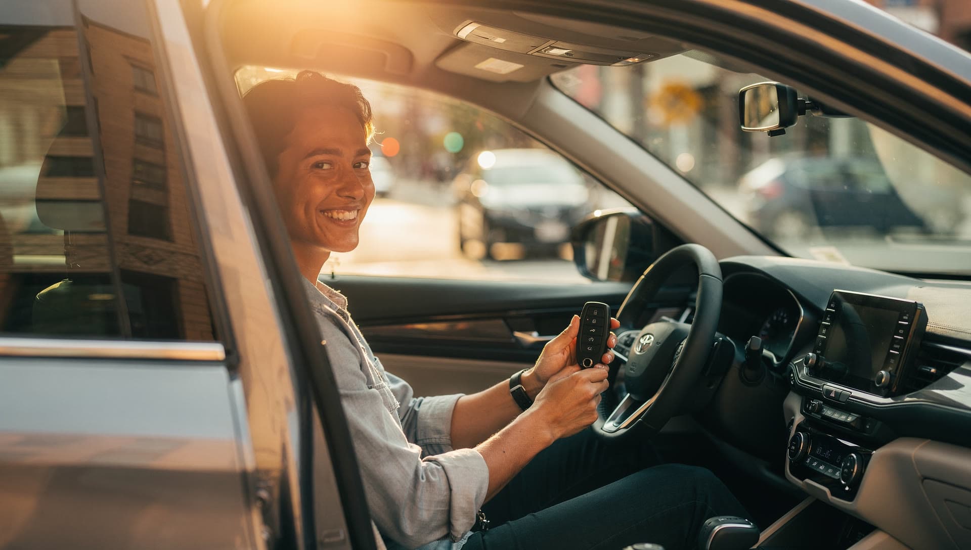 A driver in a newly financed SUV at golden hour